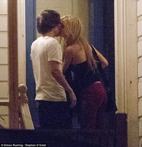 Good night kiss: Harry Styles looks like he's taken again as he was spotted giving a long goodnight kiss to American model Emma Ostilly in the early hours of the morning  